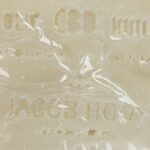 A close up of a Jacob Hooy CBD Soap bar with writing on it.