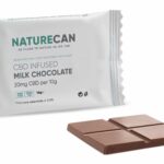 a bar of CBD dark chocolate next to a packet of CBD dark chocolate.