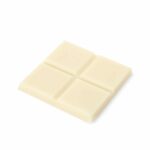 A piece of CBD white chocolate on a white background.