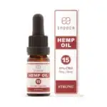 A bottle and box of Endoca - Decarb 15% CBD oil (10ml), 5mg/drop, labeled “Strong,” with red and white branding and product details.